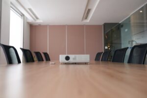 pan-shot-empty-office-with-projector-middle-conference-desk