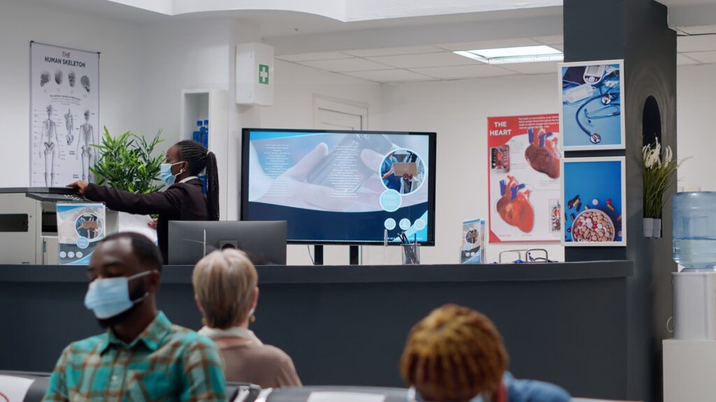 african-american-receptionist-with-face-mask-working-appointments-help-with-healthcare-service-support-hospital-employee-analyzing-checkup-reports-reception-desk