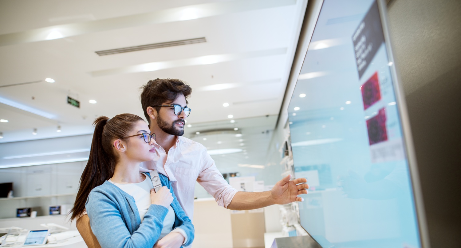 joyful-young-attractive-multiracial-couple-checking-out-plasma-tvs-electronic-store