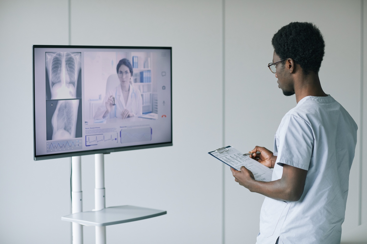 back-view-african-american-doctor-speaking-female-expert-by-video-call-clinic-copy-space